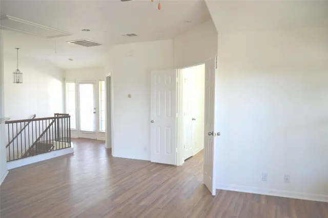 a view of a hallway with wooden floor