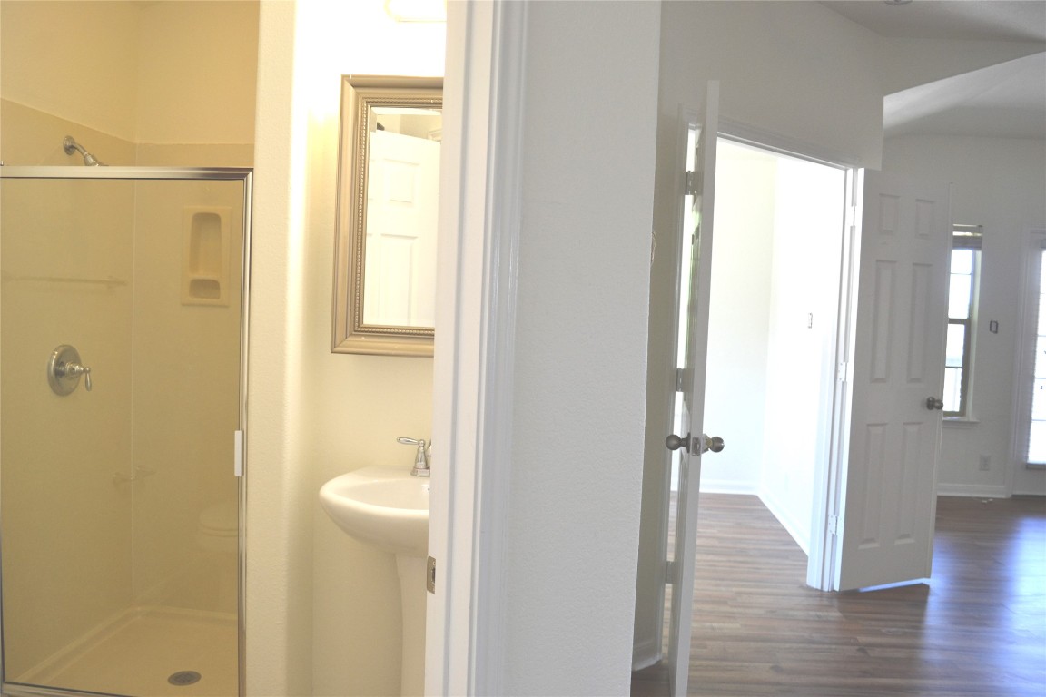9201 Brodie Lane, Unit 101 Austin, TX 78748 - Photo 21 of 24 a bathroom with a glass shower door