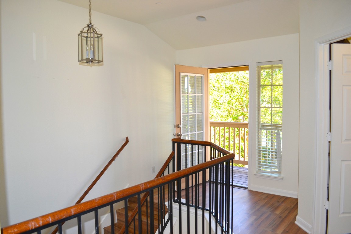 9201 Brodie Lane, Unit 101 Austin, TX 78748 - Photo 6 of 24 a view of hallway with wooden floor and stairs