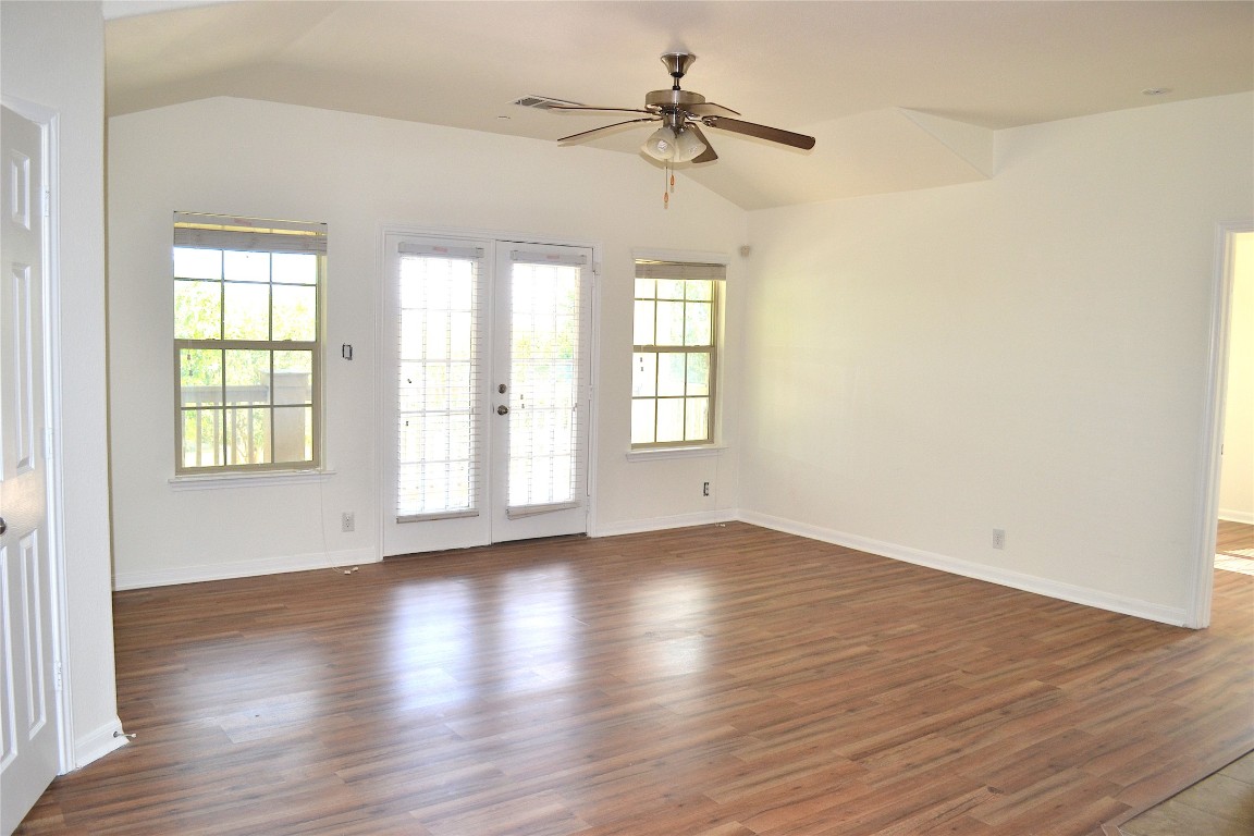 9201 Brodie Lane, Unit 101 Austin, TX 78748 - Photo 7 of 24 a view of an empty room with a window and wooden floor