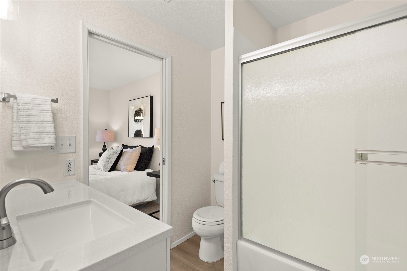 10822 East Riverside Drive, Unit A204 Bothell, WA 98011 - Photo 12 of 22 a white toilet sitting next to a bathroom sink