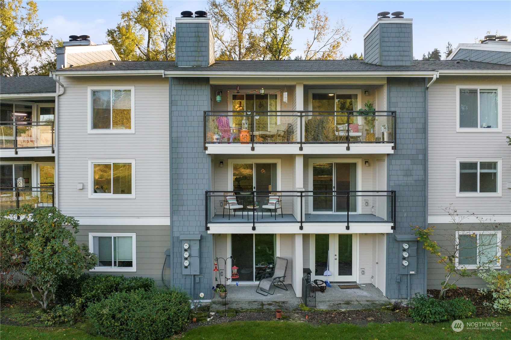 10822 East Riverside Drive, Unit A204 Bothell, WA 98011 - Photo 18 of 22 a front view of a residential apartment building with a yard