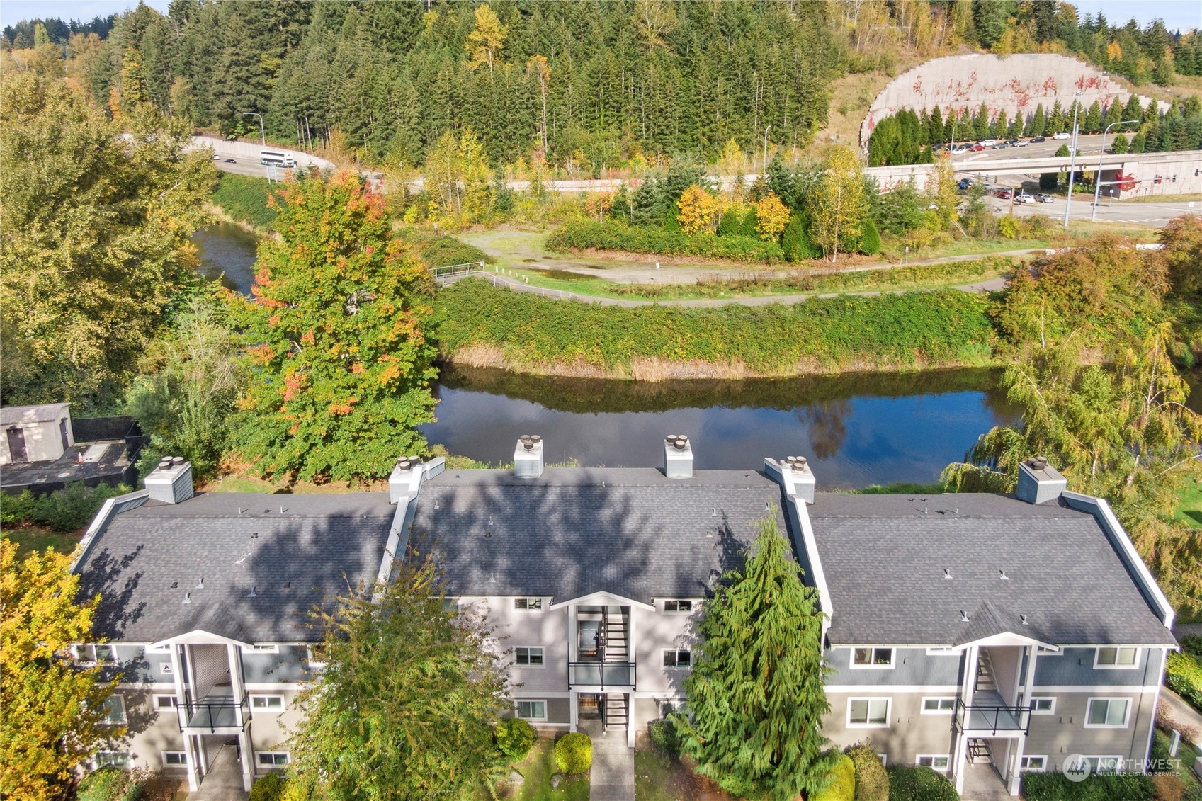 10822 East Riverside Drive, Unit A204 Bothell, WA 98011 - Photo 19 of 22 an aerial view of residential houses with outdoor space and swimming pool