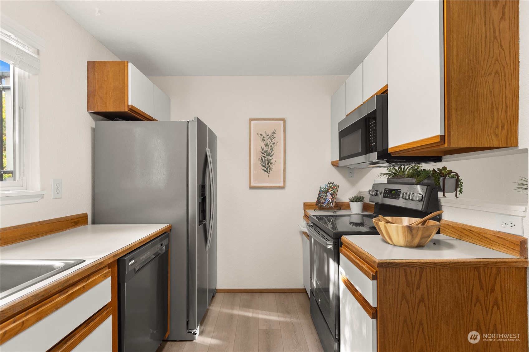 10822 East Riverside Drive, Unit A204 Bothell, WA 98011 - Photo 8 of 22 a kitchen with a refrigerator stove and microwave