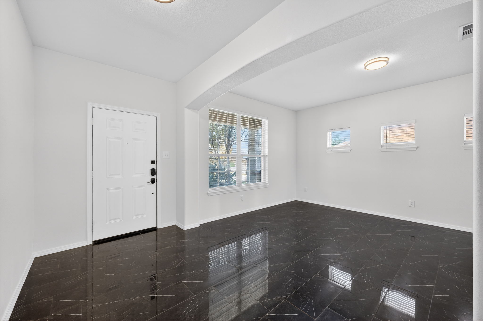 2305 Gavin Trail Pflugerville, TX 78660 - Photo 4 of 40 an empty room with wooden floor and windows