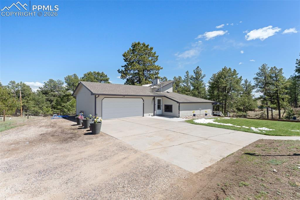 1851 Buttercup Road Elizabeth, CO 80107 - Photo 2 of 47 a view of a house with a yard and garage