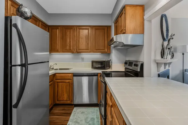 a kitchen with stainless steel appliances granite countertop a refrigerator sink and cabinets