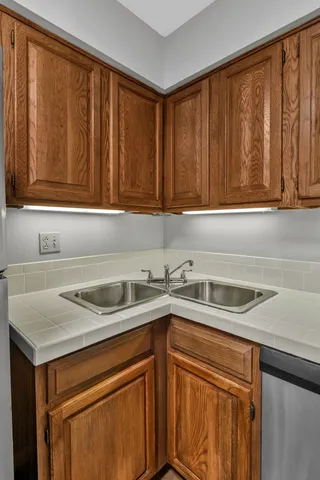 a kitchen with a sink cabinets and a window