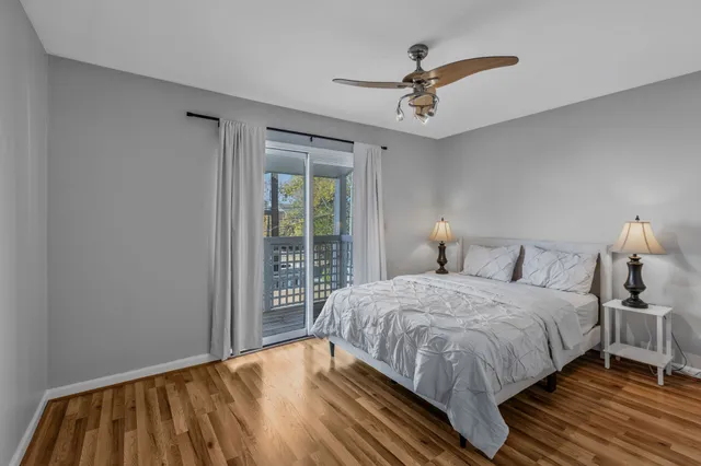 a bedroom with a bed and a ceiling fan