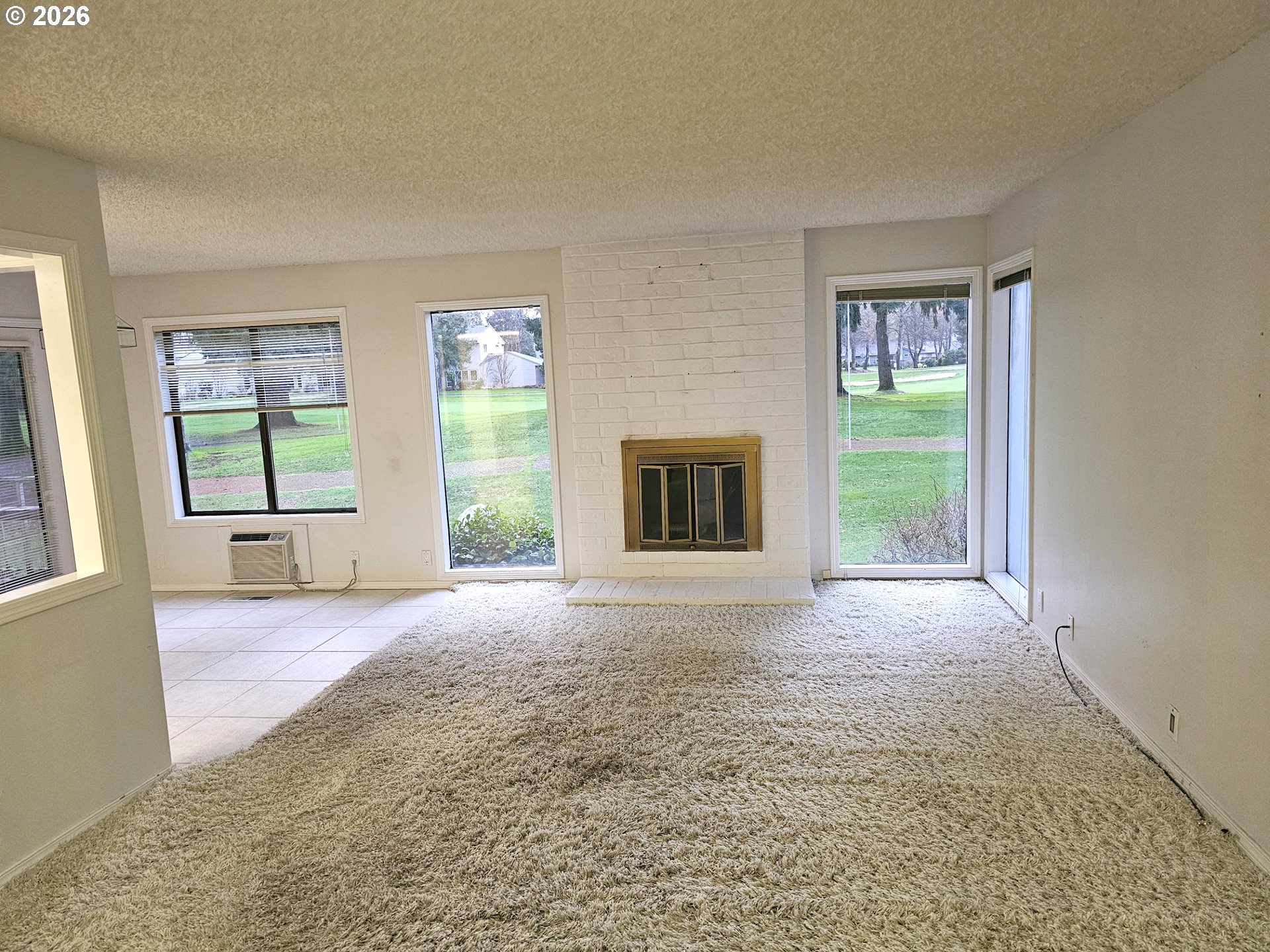8360 Southwest Mariners Drive Wilsonville, OR 97070 - Photo 6 of 10 a view of a livingroom with an empty space and a fireplace