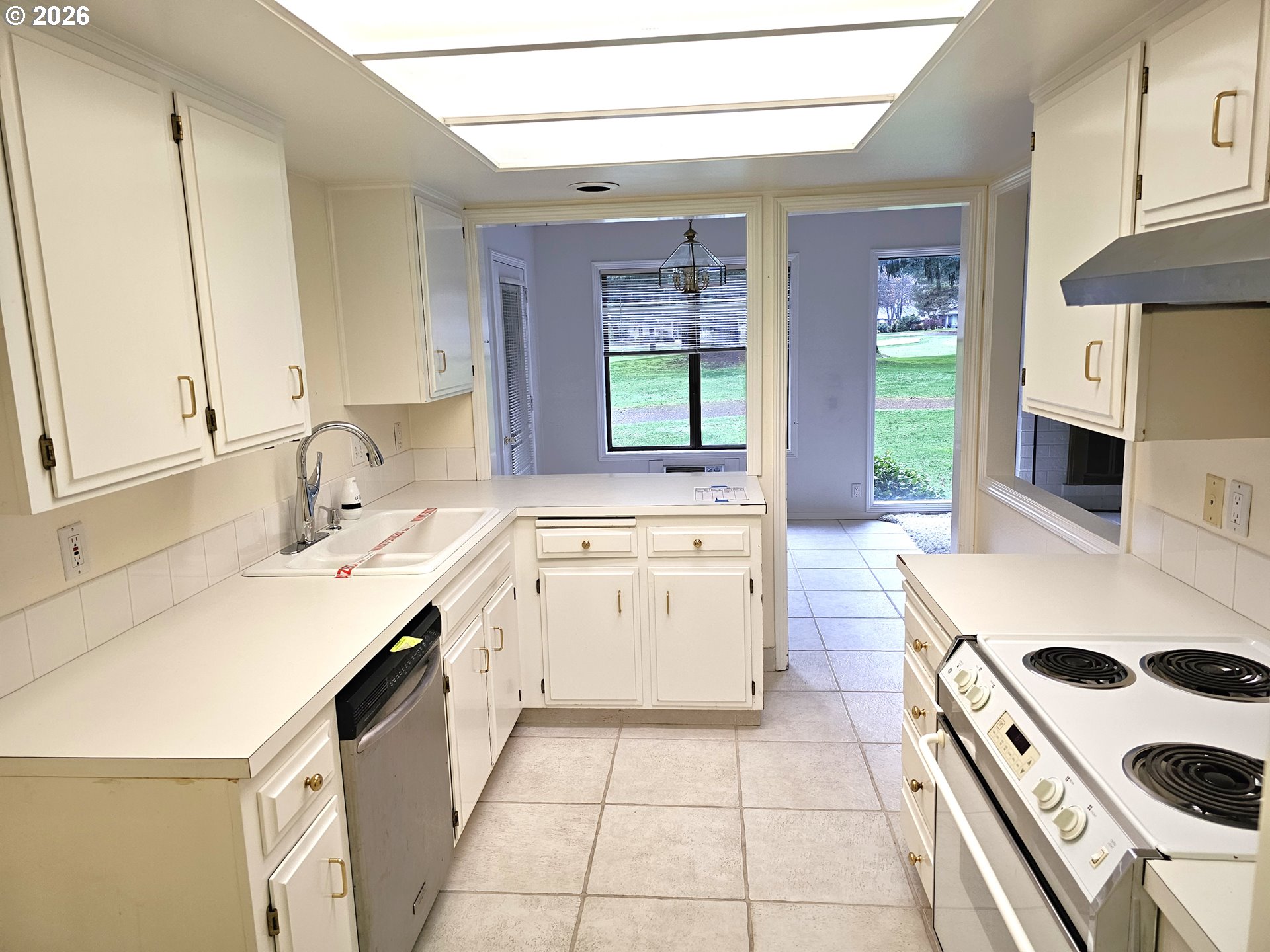 8360 Southwest Mariners Drive Wilsonville, OR 97070 - Photo 7 of 10 a kitchen with a sink a stove and cabinets