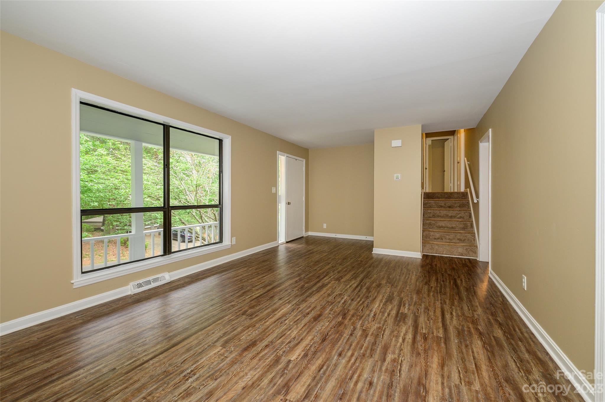 16079 Molokai Drive Tega Cay, SC 29708 - Photo 11 of 41 a view of an empty room with wooden floor and a window