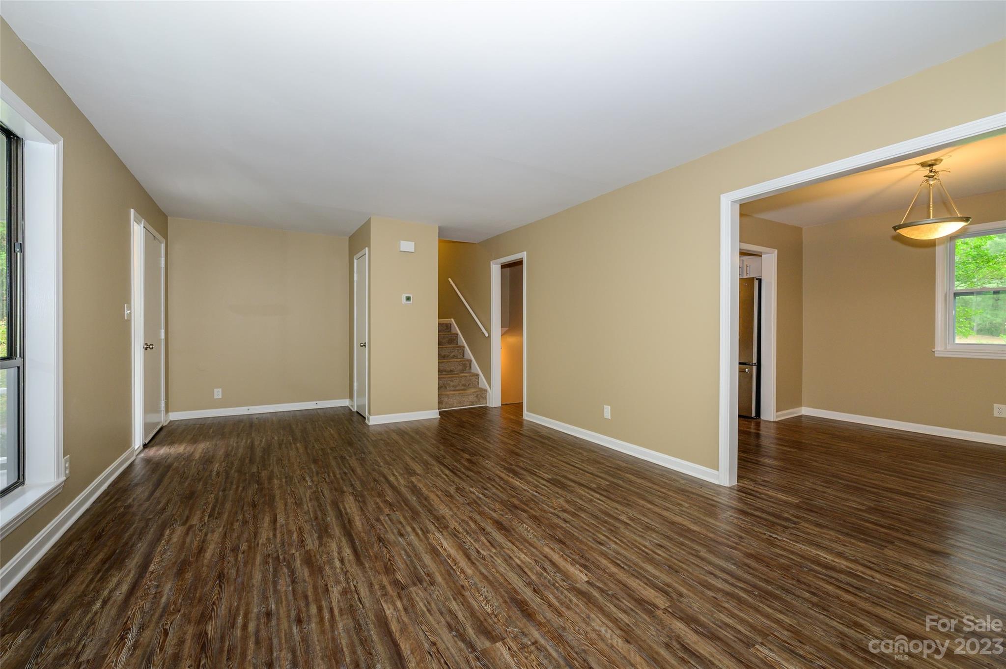16079 Molokai Drive Tega Cay, SC 29708 - Photo 12 of 41 a view of an empty room with wooden floor and a window