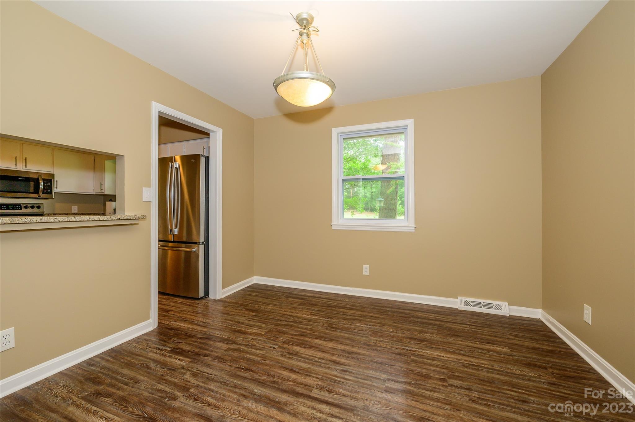16079 Molokai Drive Tega Cay, SC 29708 - Photo 13 of 41 a view of kitchen with wooden floor electronic appliances and window