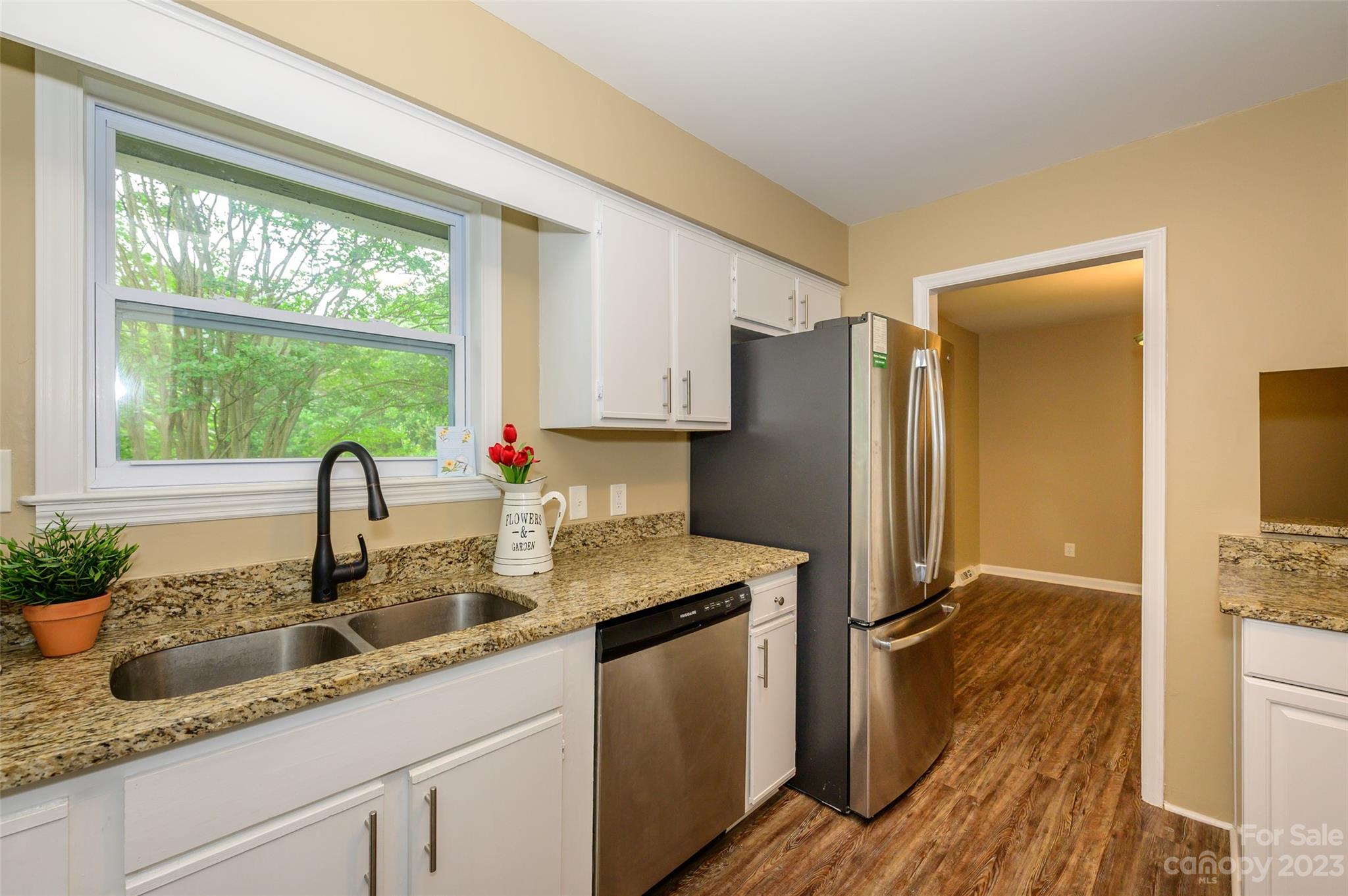 16079 Molokai Drive Tega Cay, SC 29708 - Photo 18 of 41 a kitchen with granite countertop a sink and a refrigerator