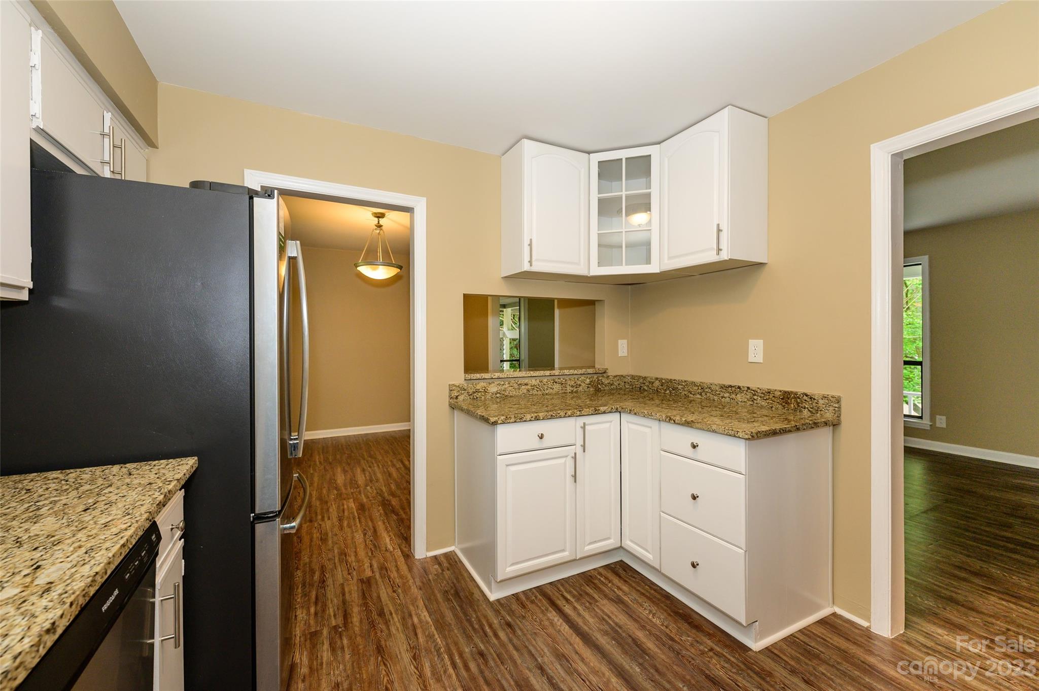 16079 Molokai Drive Tega Cay, SC 29708 - Photo 19 of 41 a kitchen with granite countertop white cabinets and refrigerator