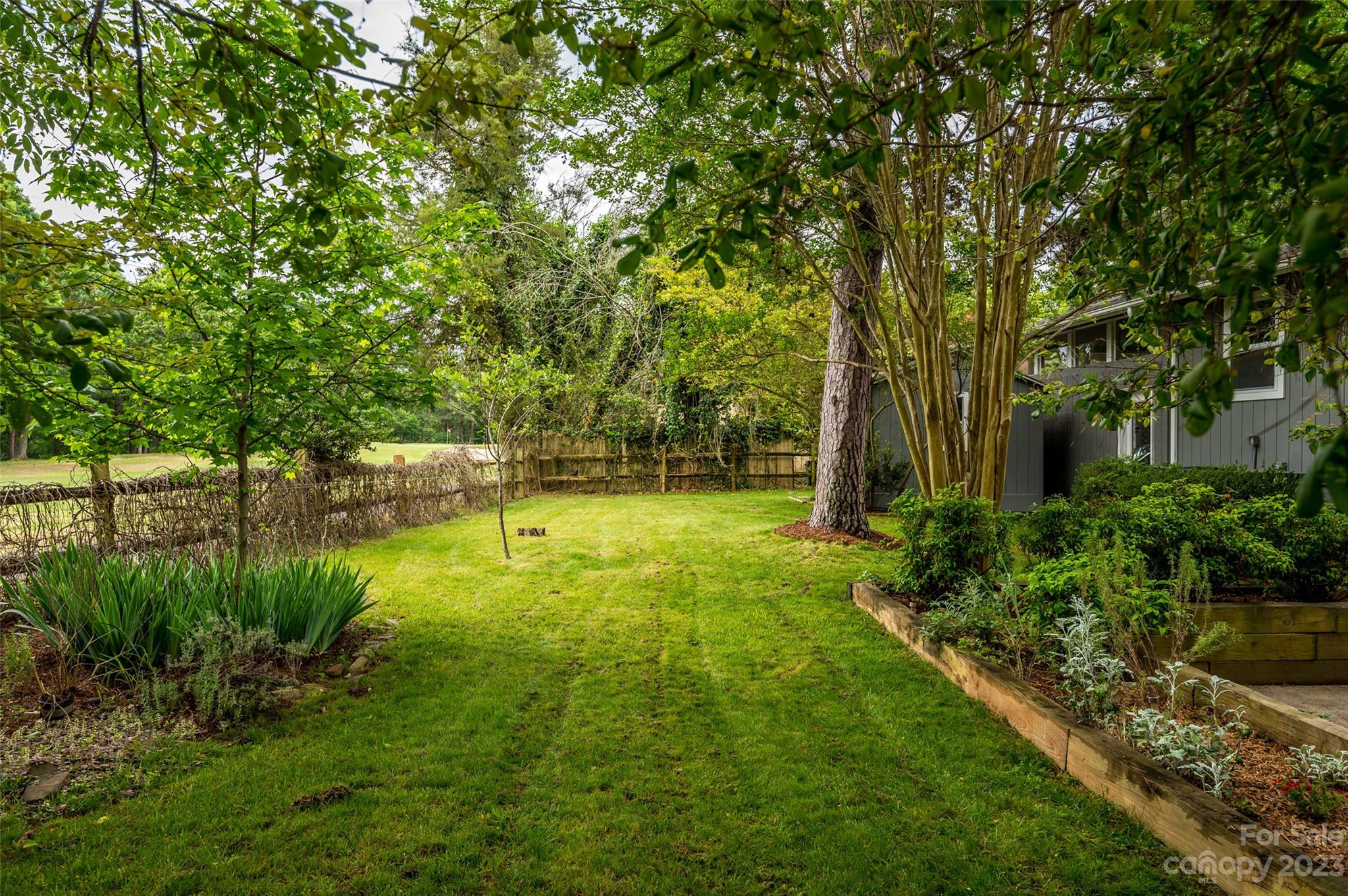 16079 Molokai Drive Tega Cay, SC 29708 - Photo 40 of 41 a backyard of a house with lots of green space