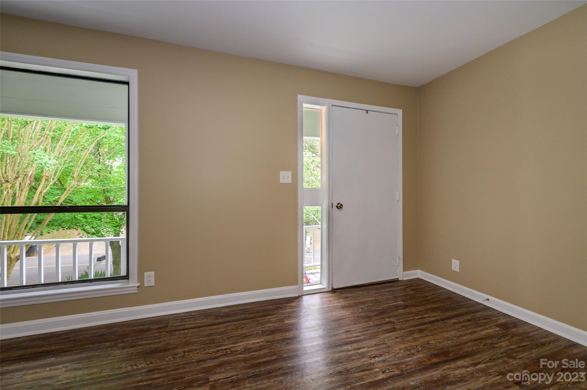16079 Molokai Drive Tega Cay, SC 29708 - Photo 7 of 41 a view of an empty room with wooden floor and a window