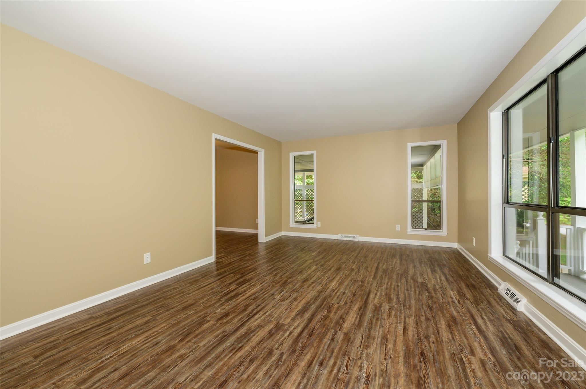 16079 Molokai Drive Tega Cay, SC 29708 - Photo 8 of 41 a view of an empty room with wooden floor and a window