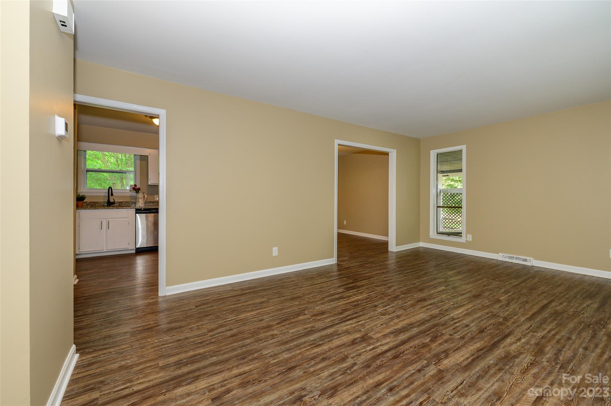 16079 Molokai Drive Tega Cay, SC 29708 - Photo 9 of 41 a view of an empty room with a window and wooden floor
