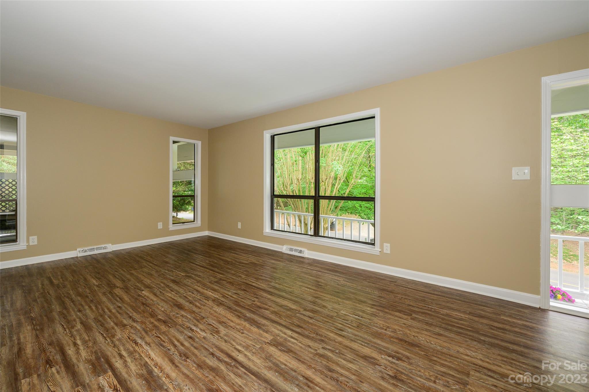 16079 Molokai Drive Tega Cay, SC 29708 - Photo 10 of 41 a view of an empty room with wooden floor and a window