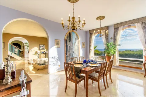 a view of a dining room with furniture and a chandelier