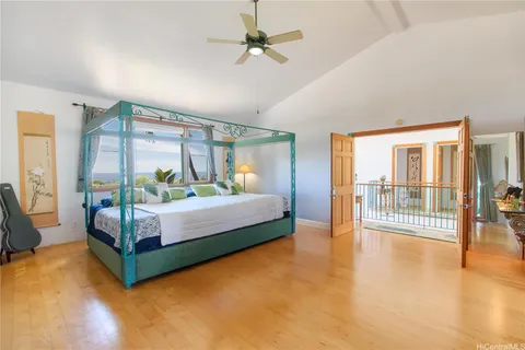 a bedroom with a bed and large glass window