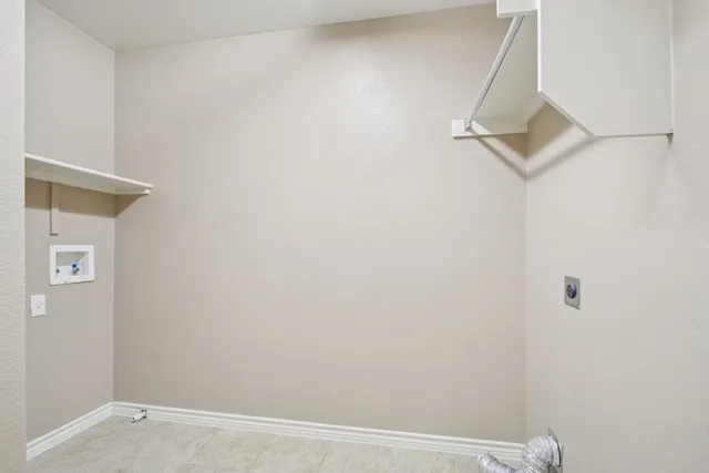 a bedroom with a large bed a chandelier and a window