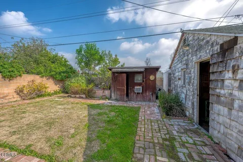 a view of a porch with plants and a yard