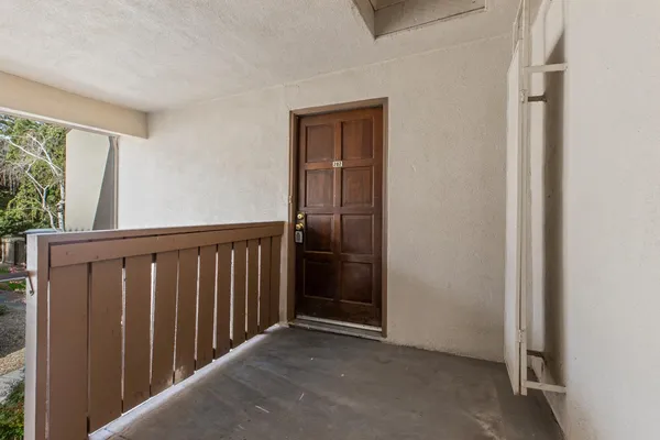 a view of a hallway with wooden floor and entryway