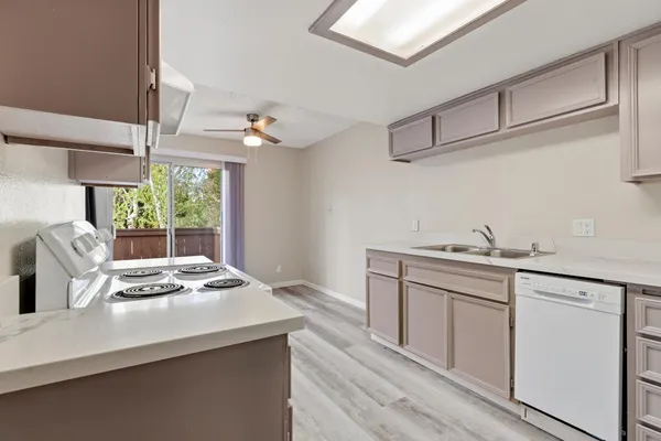 a kitchen with sink cabinets and wooden floor
