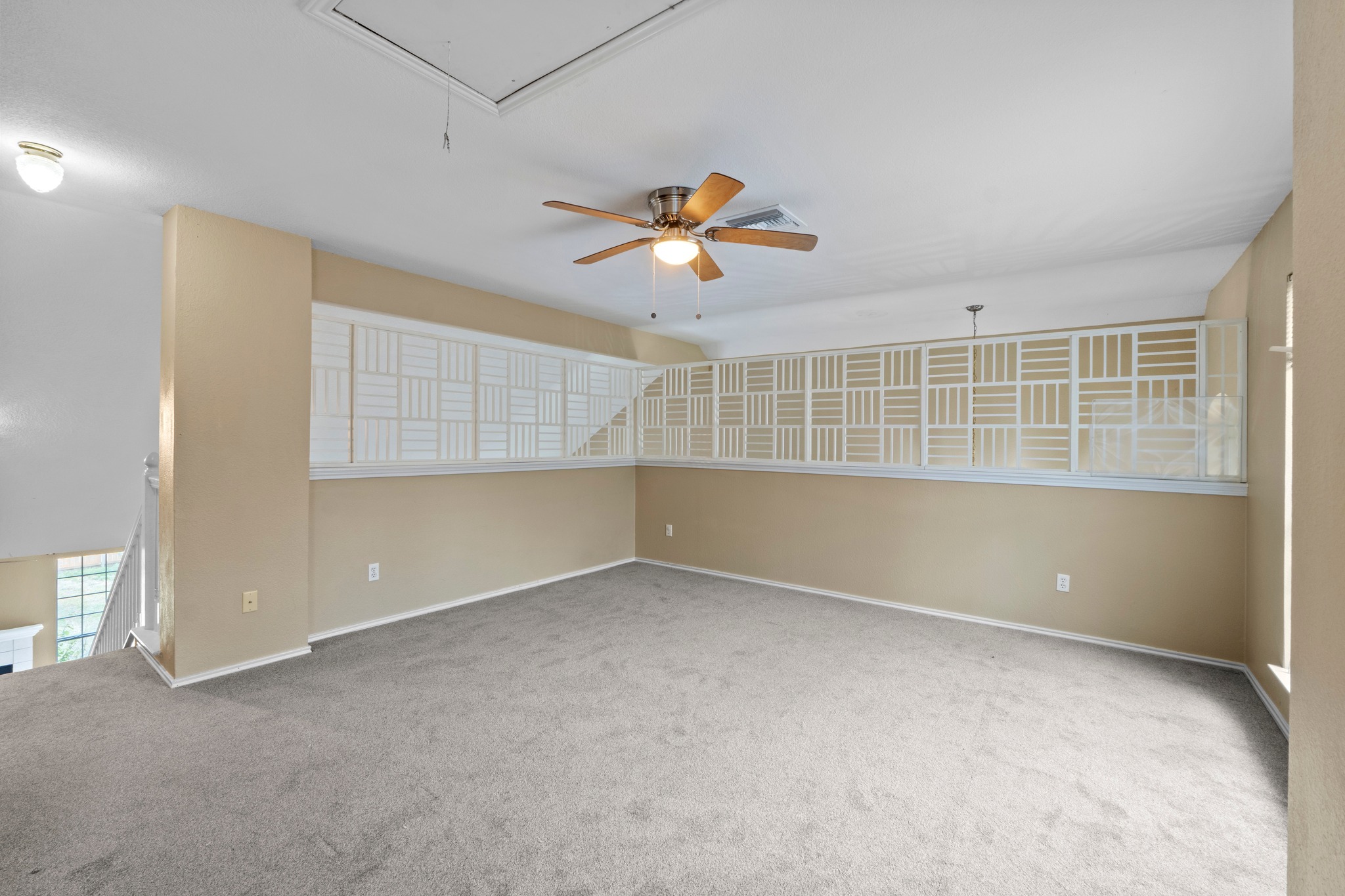 8605 Axis Drive Austin, TX 78749 - Photo 25 of 38 A versatile loft space offers a neutral palette and ample room for various uses, complete with a ceiling fan for comfort.
