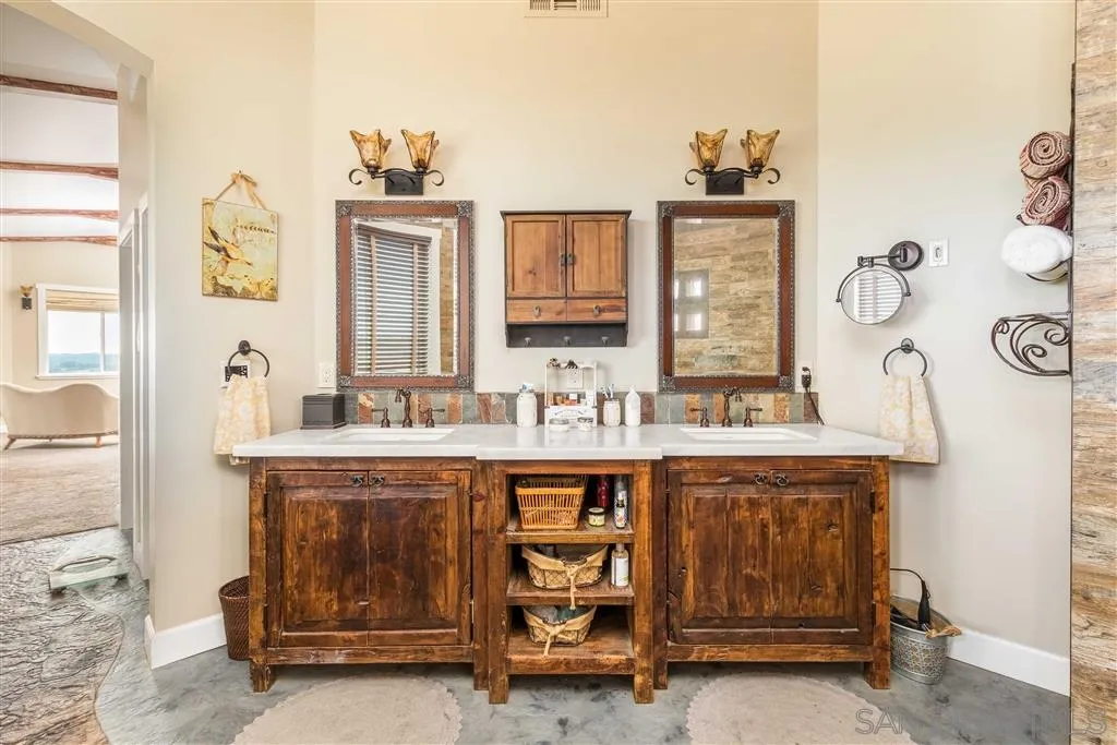 3507 Monserate Hill Road Fallbrook, CA 92028 - Photo 15 of 25 a spacious bathroom with a double vanity sink and a mirror