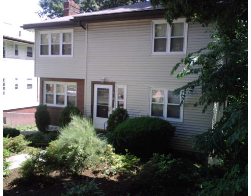 20 Cummings Road Boston, MA 02135 - Photo 1 of 1 a view of a house with a yard and plants