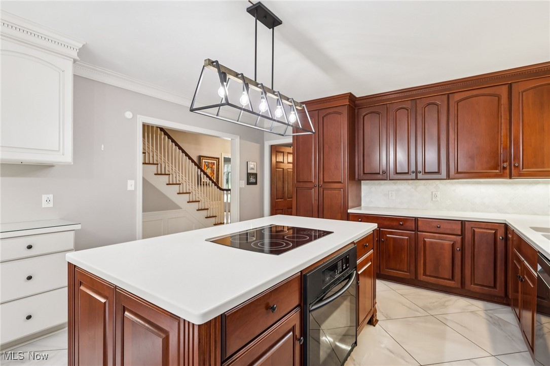 75 North Wheaton Road Akron, OH 44313 - Photo 10 of 40 Kitchen with black appliances, light marble finish floors, a kitchen island, light countertops, and pendant lighting