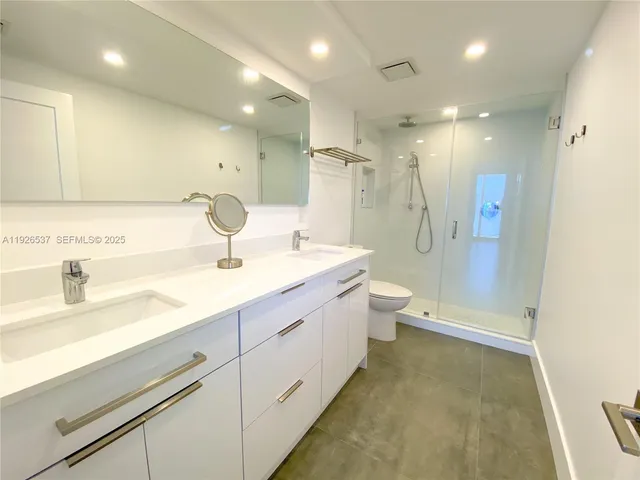 a bathroom with a sink and a large mirror