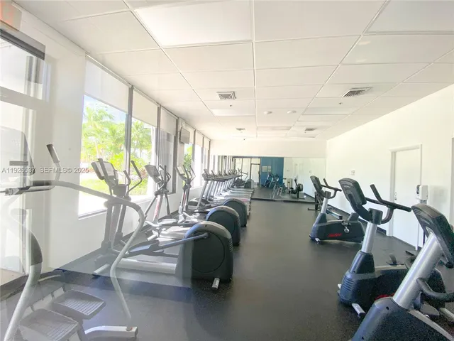 a dining room with furniture and a chandelier