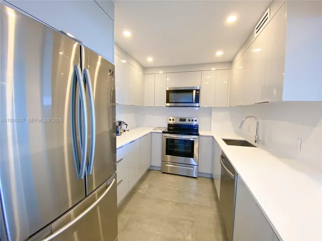 a kitchen with stainless steel appliances a refrigerator stove microwave and sink