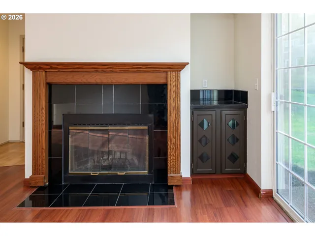 a living room with a fireplace and a rug