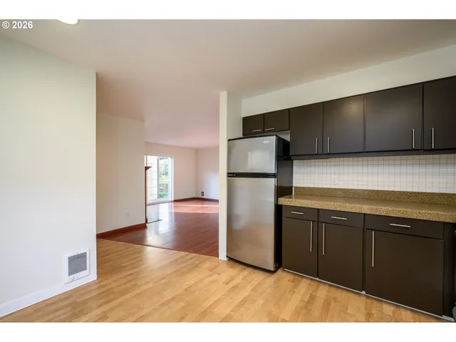 a kitchen with a refrigerator and a sink