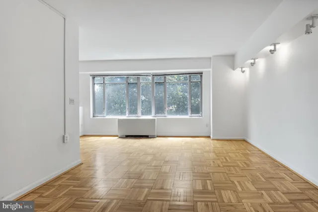 a picture of a bench in front of a wall