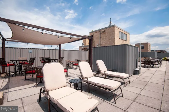 a view of a hallway with wooden floor and a bathroom
