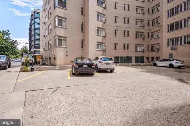 a view of a building with garden and trees