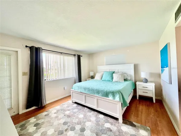 a bed room with a bed and a window