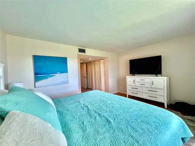 a bedroom with a bed and flat screen tv