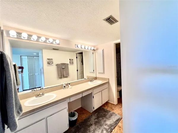 a bathroom with a double vanity sink and a mirror