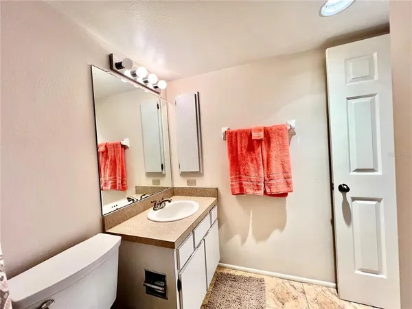 a bathroom with a sink a toilet and mirror
