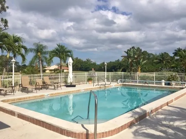 a view of a swimming pool with a lawn chairs