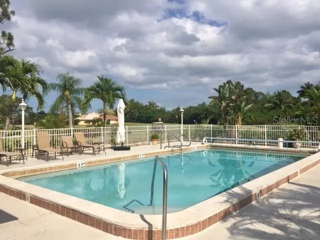 a view of a swimming pool with a lawn chairs