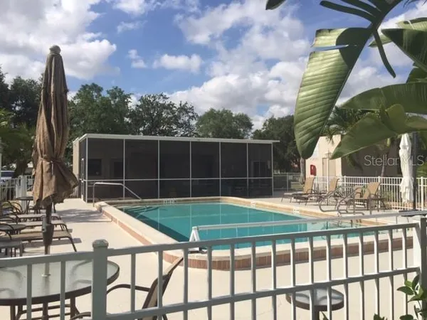 a view of a patio with a table chairs and a fire pit